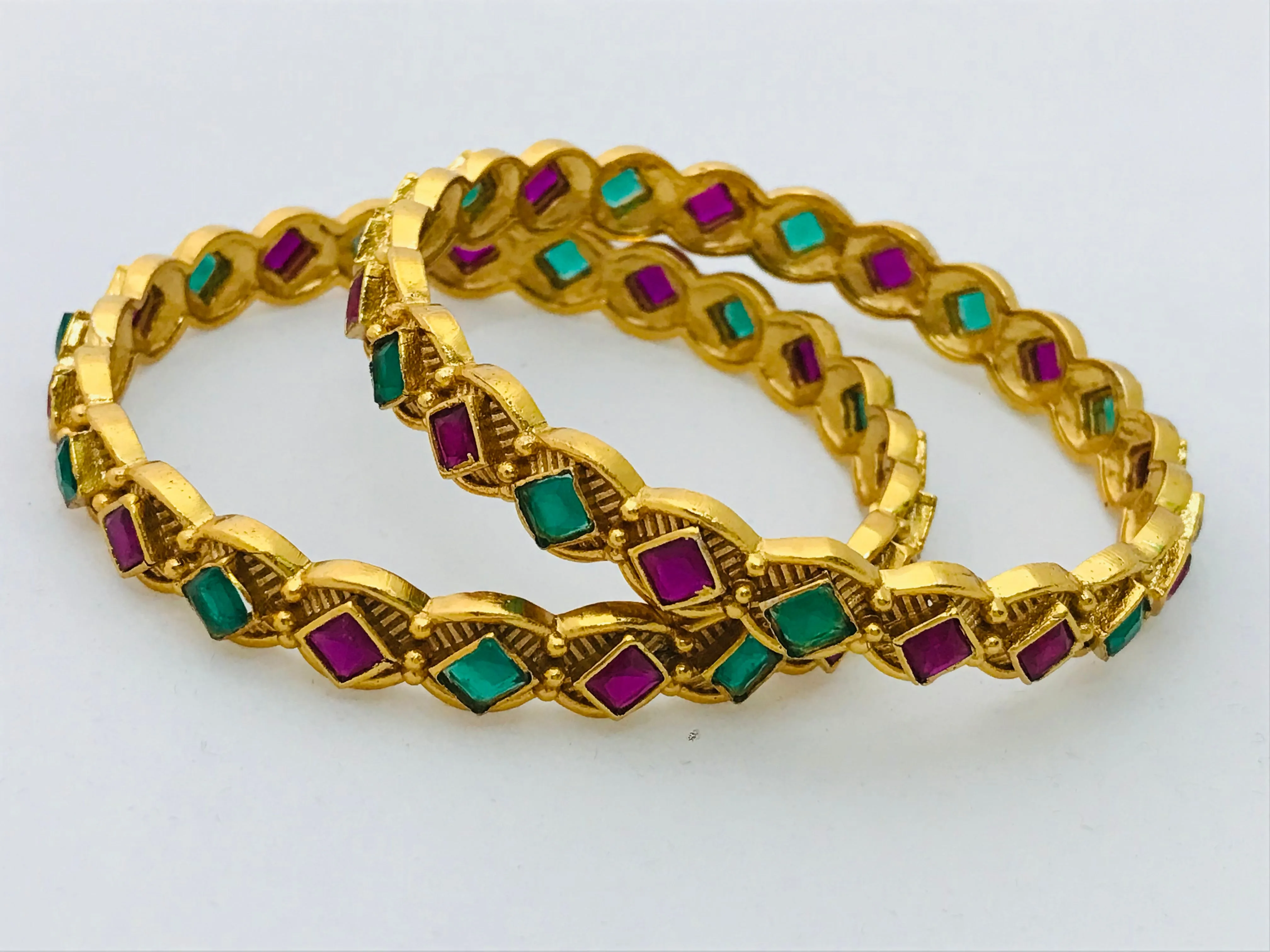 Beautiful Matte Finished Antique Gold Bangle Set With Emerald And Ruby Stones