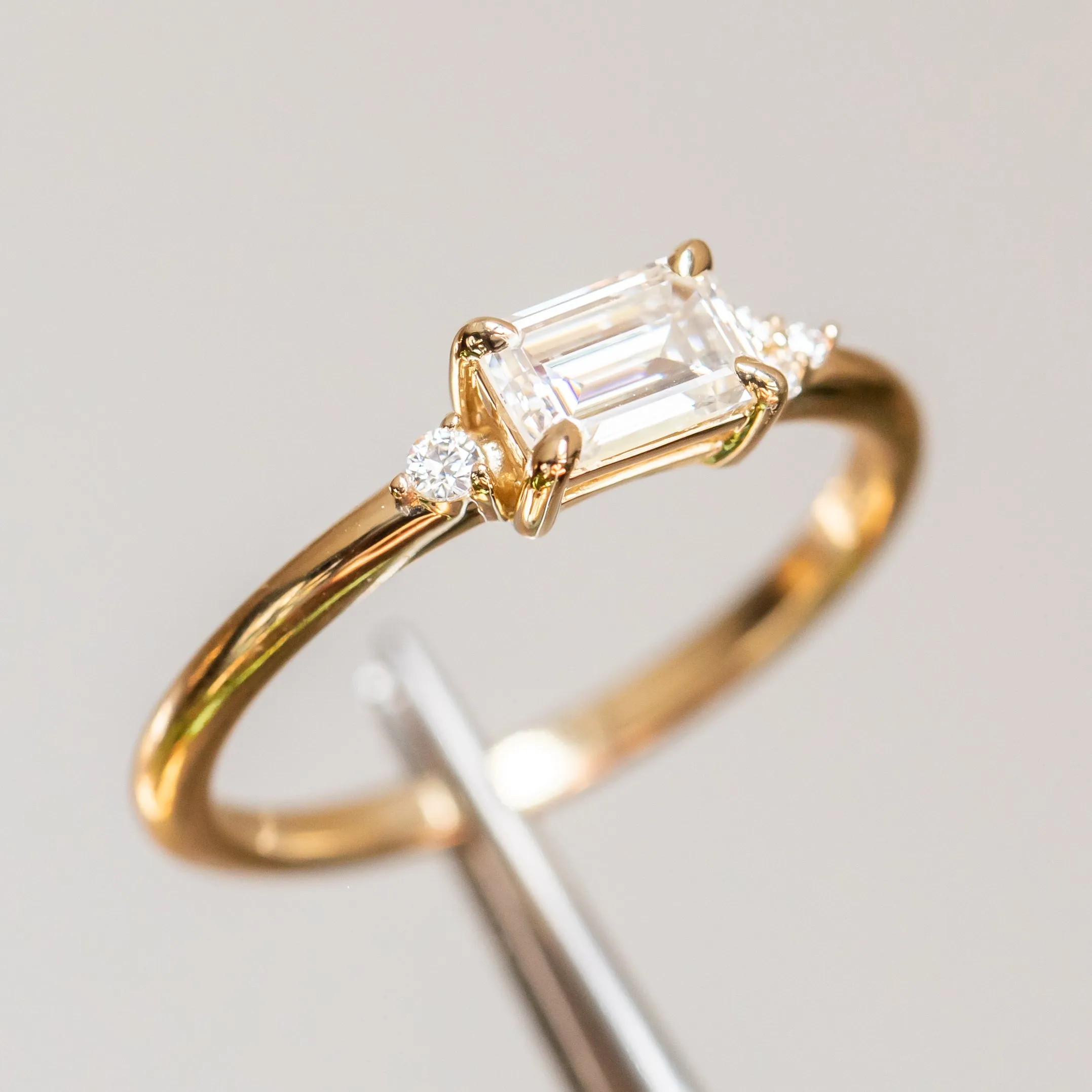 East-West Emerald cut Moissanite Asymmetrical Ring in 14k Yellow Gold