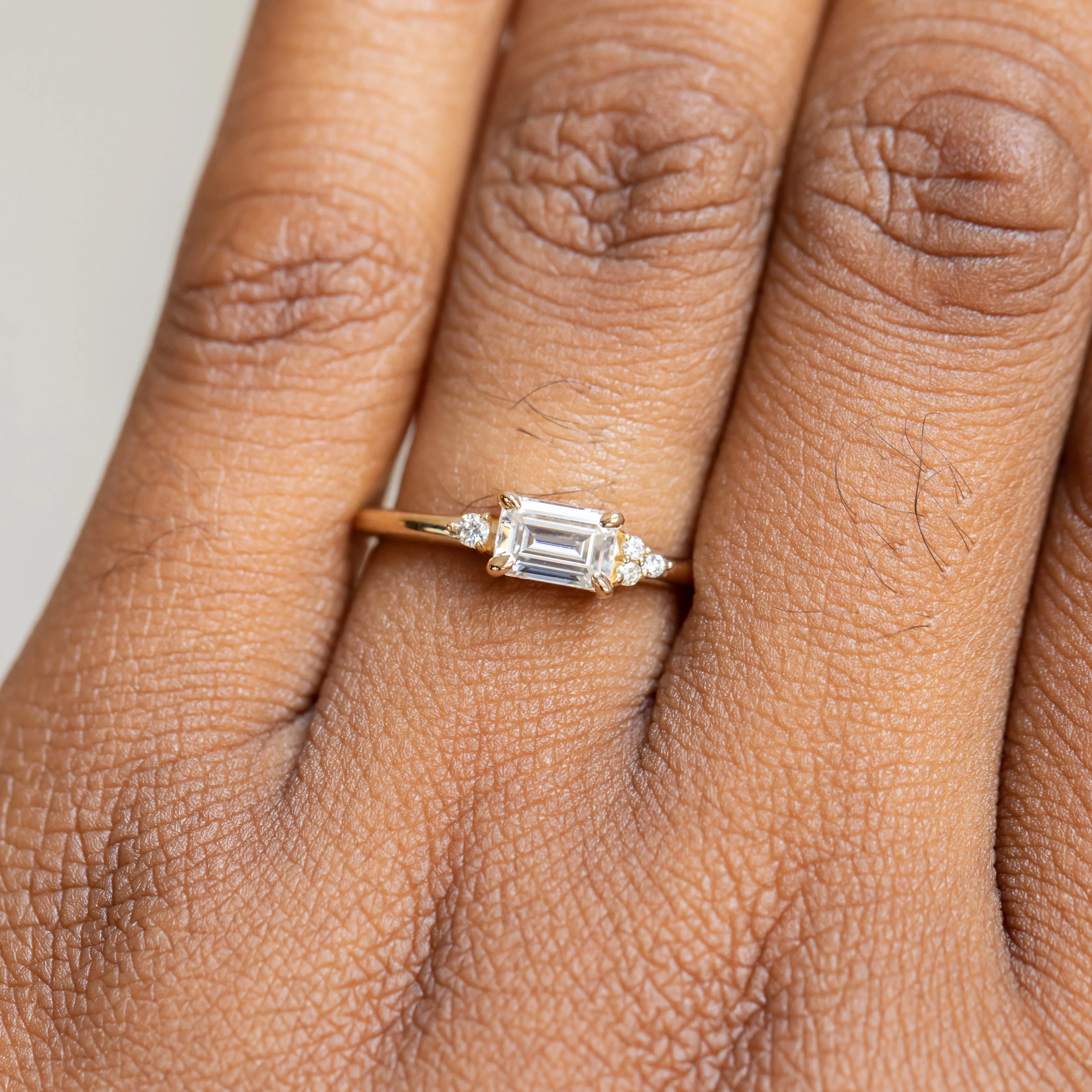 East-West Emerald cut Moissanite Asymmetrical Ring in 14k Yellow Gold